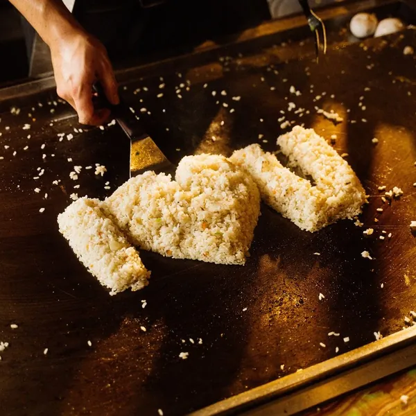 Hibachi chef searing scallops and fried rice