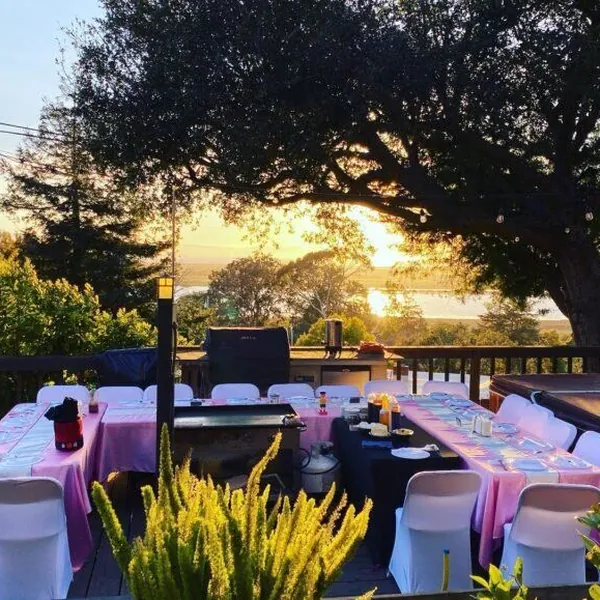 Hibachi party tables on a patio at sunset