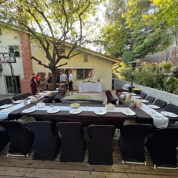 Backyard hibachi party table setup beside the house